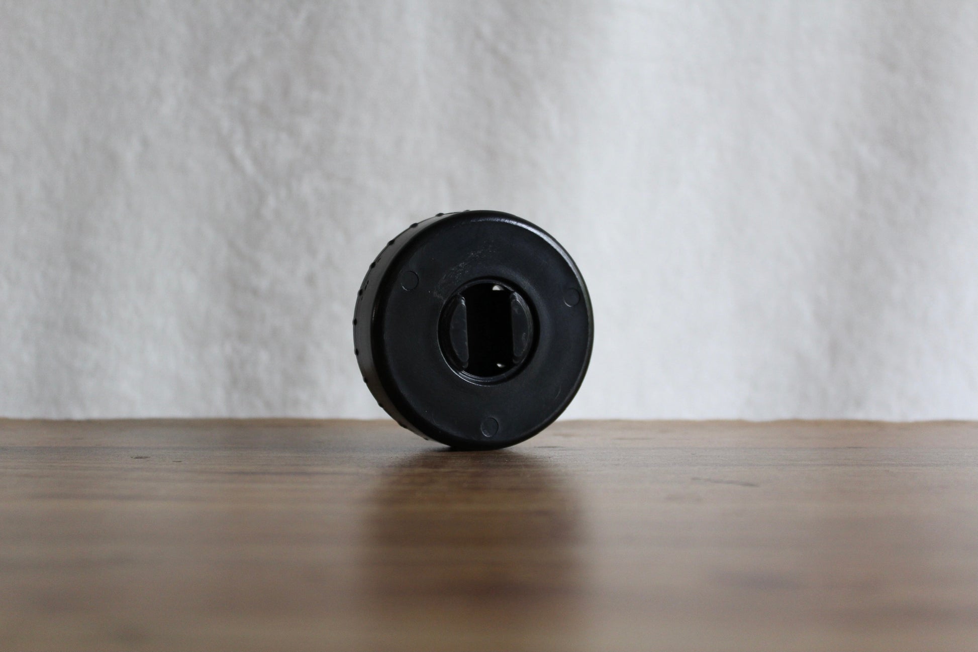 Black-colored CordPuck cord organizer