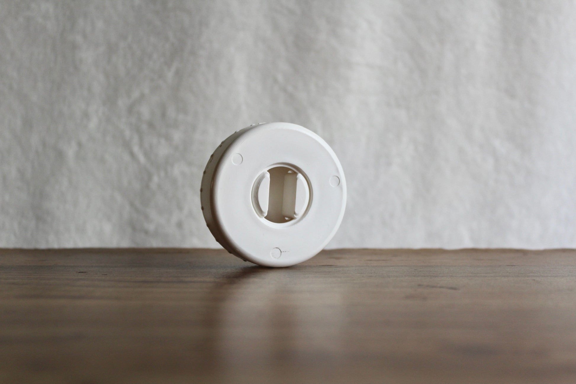 White-colored CordPuck cord organizer