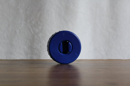 Blue-colored CordPuck cord organizer